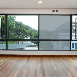 Bright room with large open windows and wooden flooring, showcasing natural light and outdoor views.